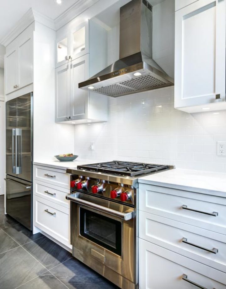 Modern white luxury kitchen with gas range at the middle