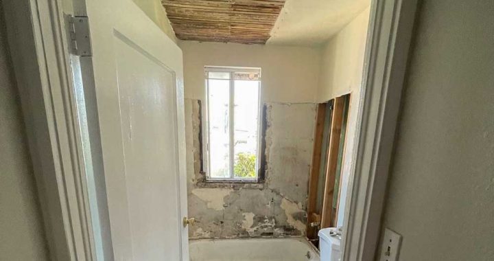 demolished ceiling and tiles on a bathroom